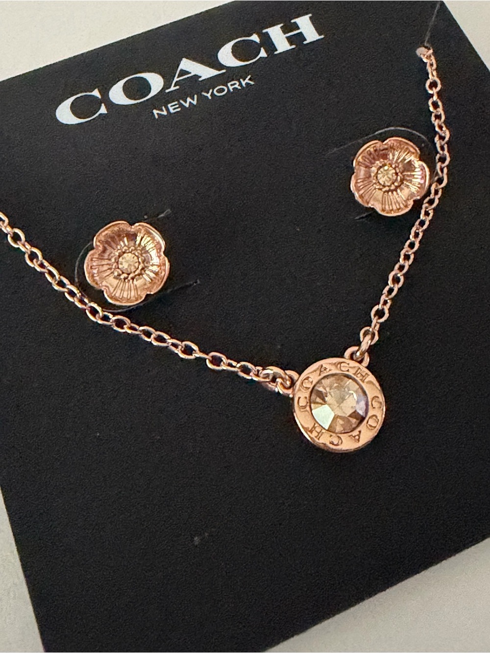 COACH Rose Gold Crystal Pendant Necklace with Floral Stud Earrings